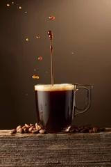 Acrylglasbilder Kaffee Bar Espresso coffee glass cup with splashes on a brown background.  © Igor Normann