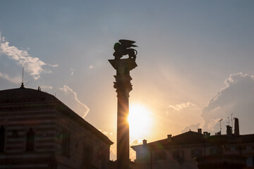 Scenic view of silhouette of statue of San Marco lion on top of column at sunrise seen from...
