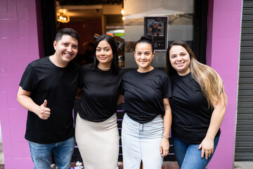 Bar workers posing together.