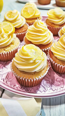 Obraz na płótnie Canvas Homemade lemon cupcakes with buttercream frosting, baking recipe