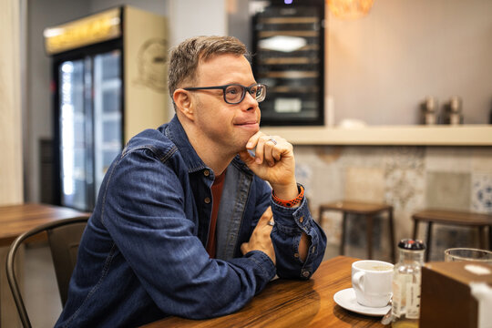 portrait of young man with down syndrome in a cafeteria