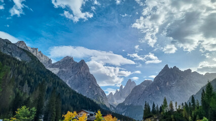 Scenic view of majestic rugged mountain peaks of Sexten Dolomites, Bolzano, South Tyrol, Italy, Europe. Hiking in panoramic Fischleintal near Moos, Italian Alps. Idyllic conifer forest. Tranquil scene - obrazy, fototapety, plakaty