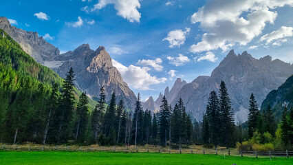 Scenic view of majestic rugged mountain peaks of Sexten Dolomites, Bolzano, South Tyrol, Italy, Europe. Hiking in panoramic Fischleintal near Moos, Italian Alps. Idyllic conifer forest. Tranquil scene - obrazy, fototapety, plakaty