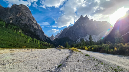 Scenic hiking trail along alpine stone field in panoramic valley Fischleintal near Moos. Panoramic...