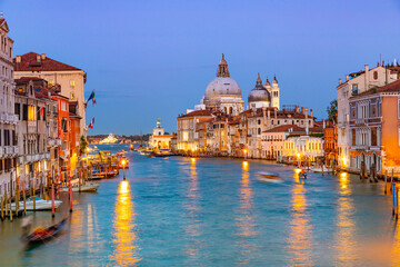 Fototapeta na wymiar Basilica of Santa Maria della Salute and Grand Canal in Venice at night, Italy