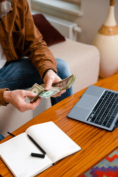 A man counts money indoors