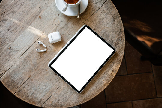 Tablet with white screen on the table