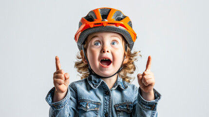 Excited Child Cyclist. Surprised boy in yellow shirt and helmet pointing upwards.