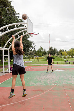 Two female athletes work on honing their throwing abilities