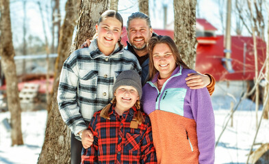 family close to a maple shack having fun together