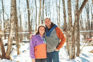 couple close to a maple shack having fun together - 777685179