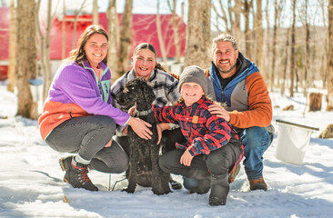 family close to a maple shack having fun together - 777685509