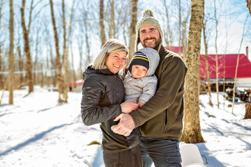 family close to a maple shack having fun together - 777685789