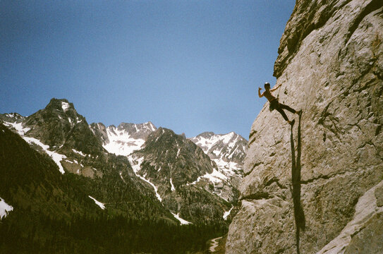 Climber hanging off rope outside.