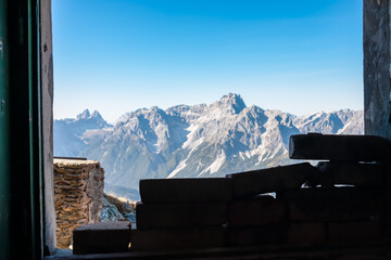 View from window of remains of military bunker First World War, mount Hornischegg. Looking at peak Dreischusterspitze in mountain range of untamed Sexten Dolomites, South Tyrol, Austria Italy, Europe - obrazy, fototapety, plakaty