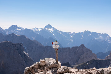 Path mark indicaring hiking trail to mount Mangart (Mangrt), border Italy Slovenia. Scenic view of...