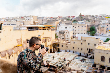A man taking photos in a tannery in Morocco