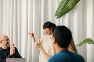 Coworkers celebrating in office