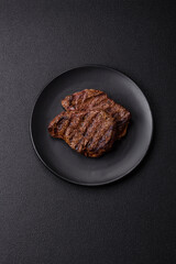 Fresh juicy delicious beef steak on a dark background