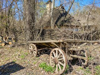 Fototapeta na wymiar Old wooden cart. Early spring landscape.