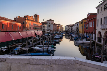 Seagull with scenic view of canal Vena after sunset in charming town of Chioggia, Venetian Lagoon,...