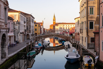 Church of Saint James Apostle with sunset view of canal Vena nestled in charming town of Chioggia,...