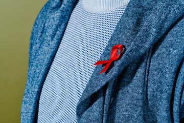 man with a red ribbon for the fight against AIDS