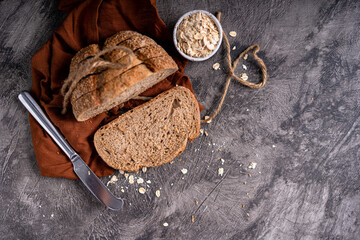 Fresh slices of home baked artisan sourdough bread on white rustic dark background. german rye bread