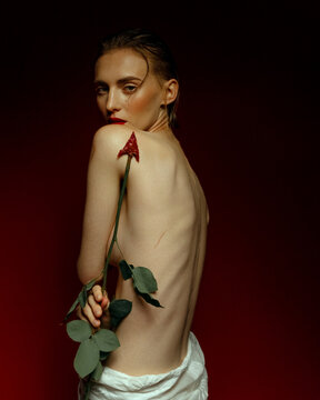 Sensual portrait of a model with a rose arrow