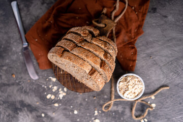 Fresh slices of home baked artisan sourdough bread on white rustic dark background. german rye bread