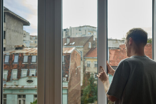 Young man fixing a window