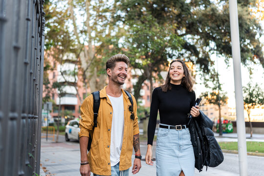 portrait of smiling couple walking together in city