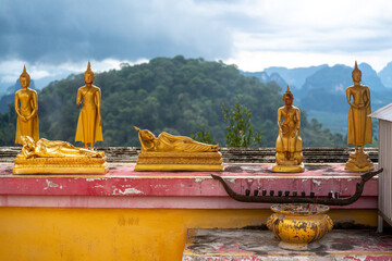 miniature buddhas against the backdrop of a mountain landscape