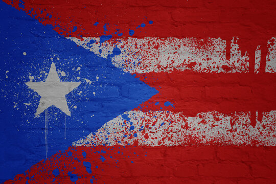 painted big national flag of puerto rico on a massive old brick wall