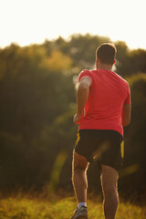 Rearview, man and running for exercise, fitness goals and workout for body health and physical...