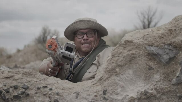 Man in scout uniform with toy gun yelling - medium shot