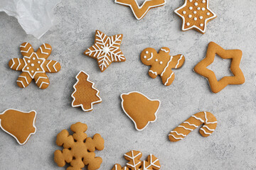 Christmas gingerbread cookies of various shapes on a gray background.
