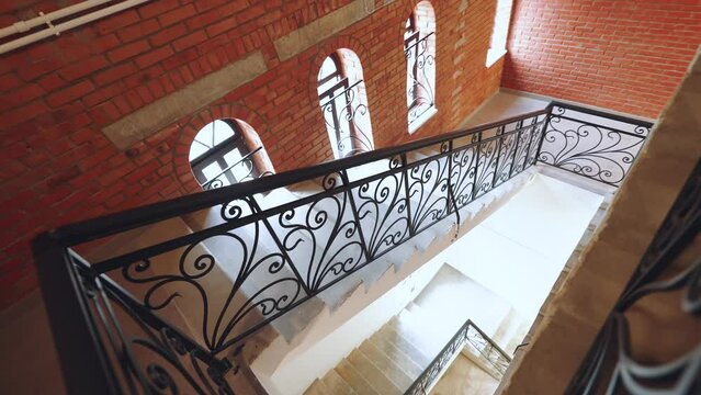 Stairs in a brick building, stairs with wrought iron railings