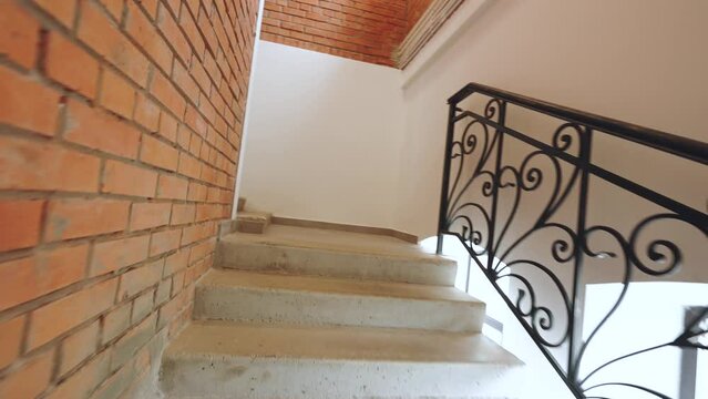 Stairs in a brick building, stairs with wrought iron railings