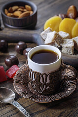 Ethnic cup of coffee and turkish delight on table - 777701595