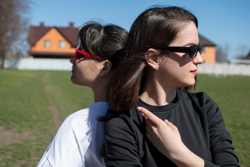 Close up portrait of a two young women in sunglasses	