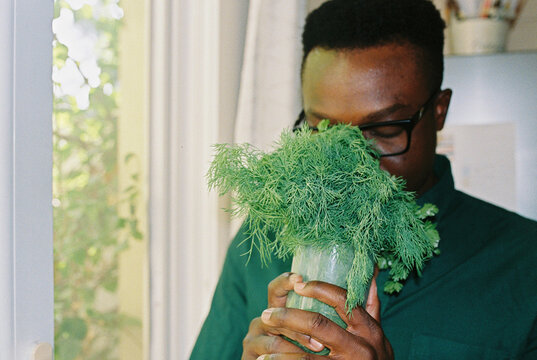 A young man with a bunch of dill
