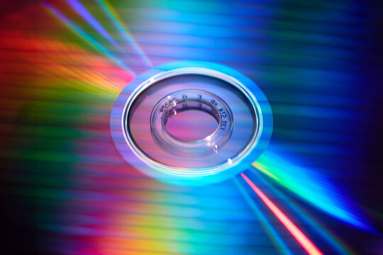 Rainbow reflection on smooth mirrored surface of CD disc