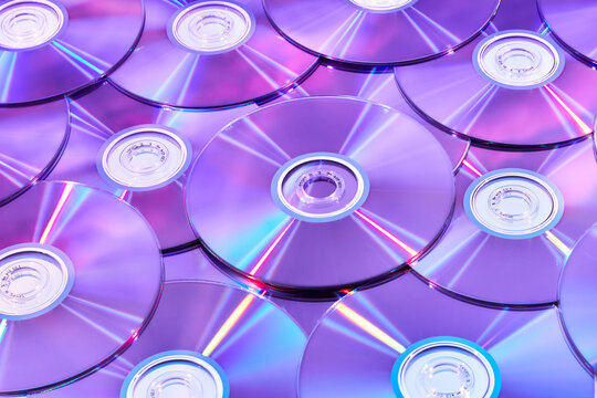 Creative seamless pattern of compact discs with violet neon light