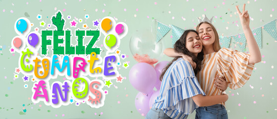 Happy young women celebrating Birthday on green background