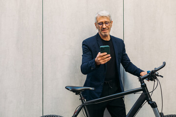 Senior man using smartphone outside