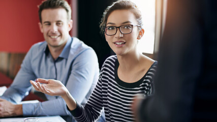 Business, leader and woman in meeting, talking and discussion with colleagues, teamwork and corporate. Workforce, collaboration and female person giving suggestion on project, copywriter and employee