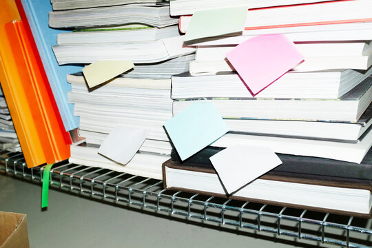 Modern office view with books, magazines & colourful post it notes 