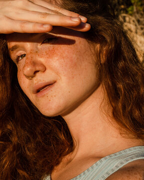 Sunny portrait of woman with freckles 