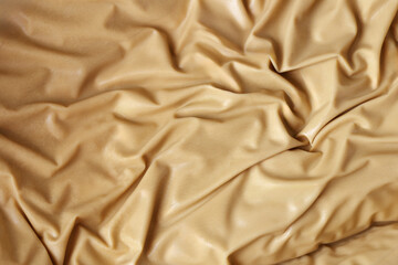 A piece of leather with a wrinkled texture. The leather appears to be tan in color and has a...